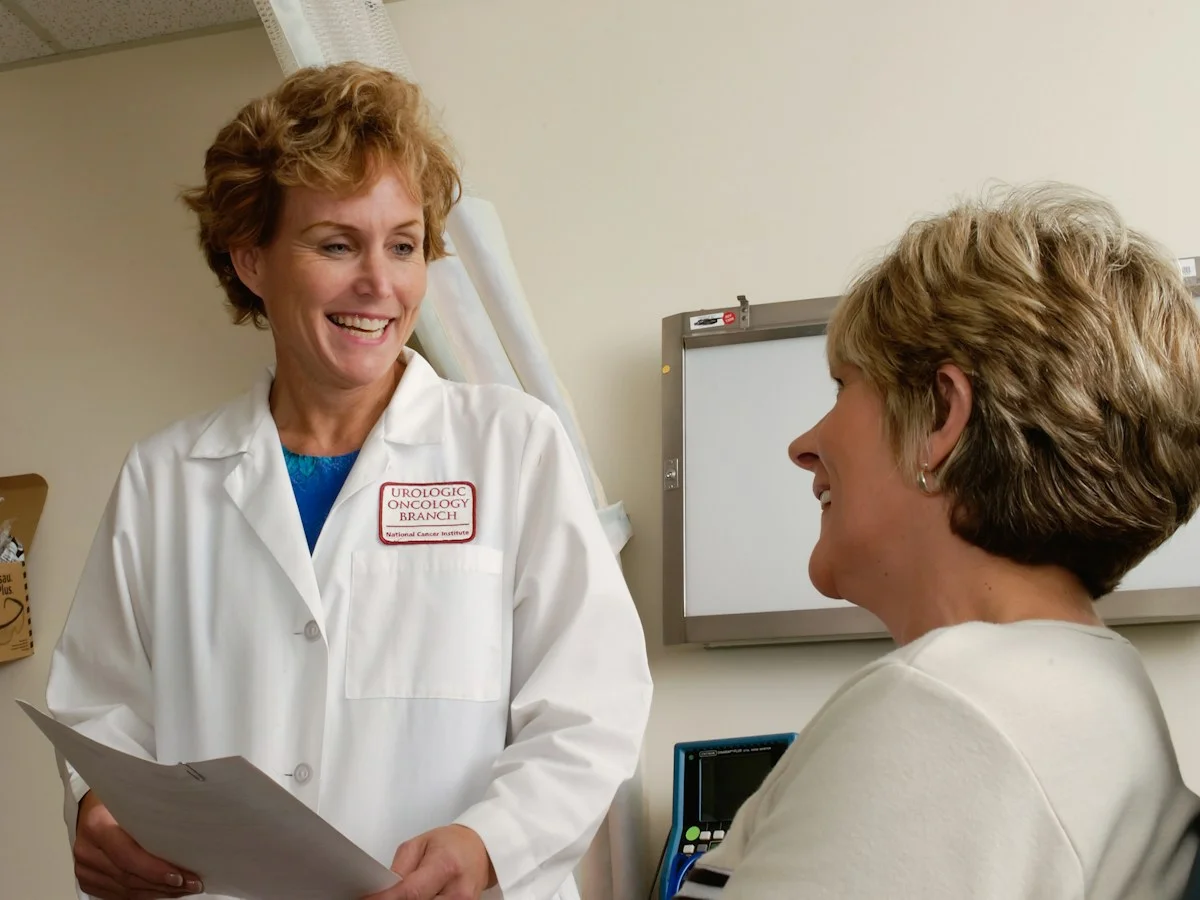A physician talking with a patient in an examination room