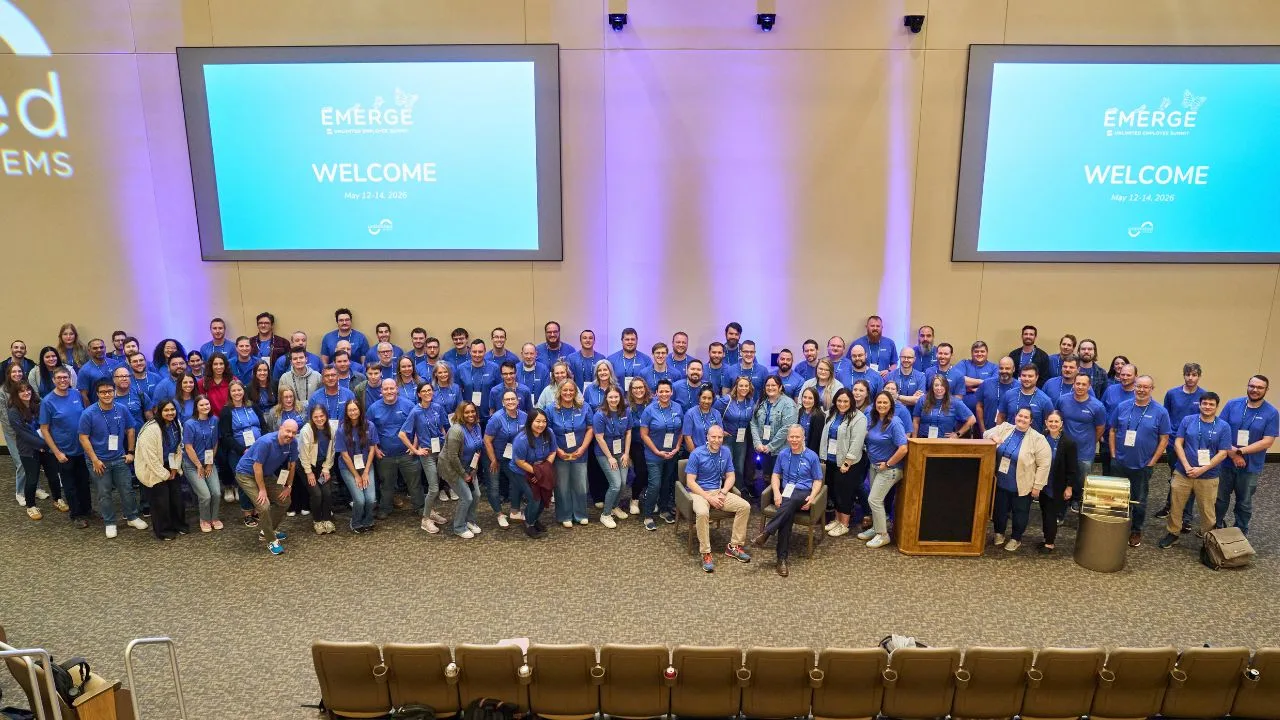 The Unlimited Systems team gathered on stage at the EMERGE Unlimited Employee Summit