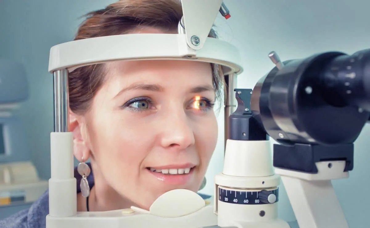 Patient positioned at a slit lamp for an eye exam