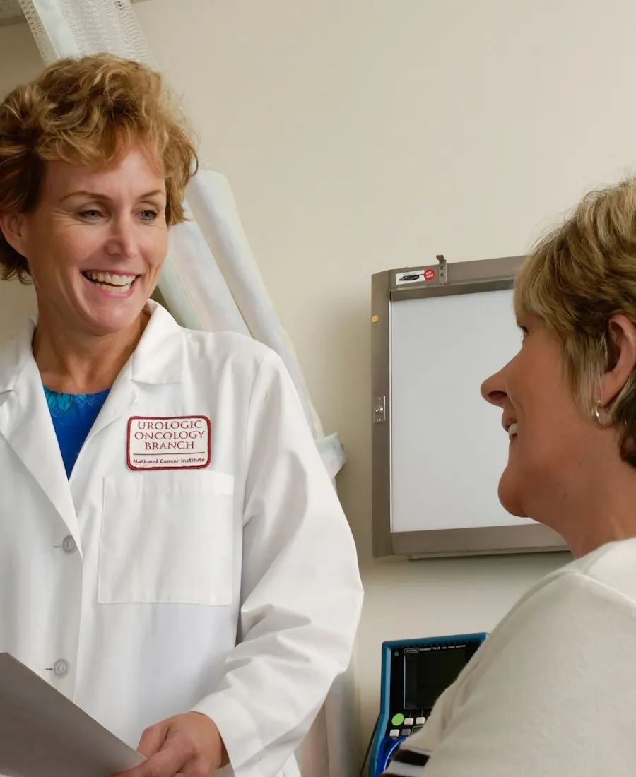 Physician in a white coat talking with a patient