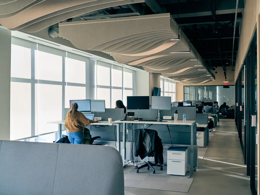Unlimited Systems staff at standing desks in the open Cincinnati workspace