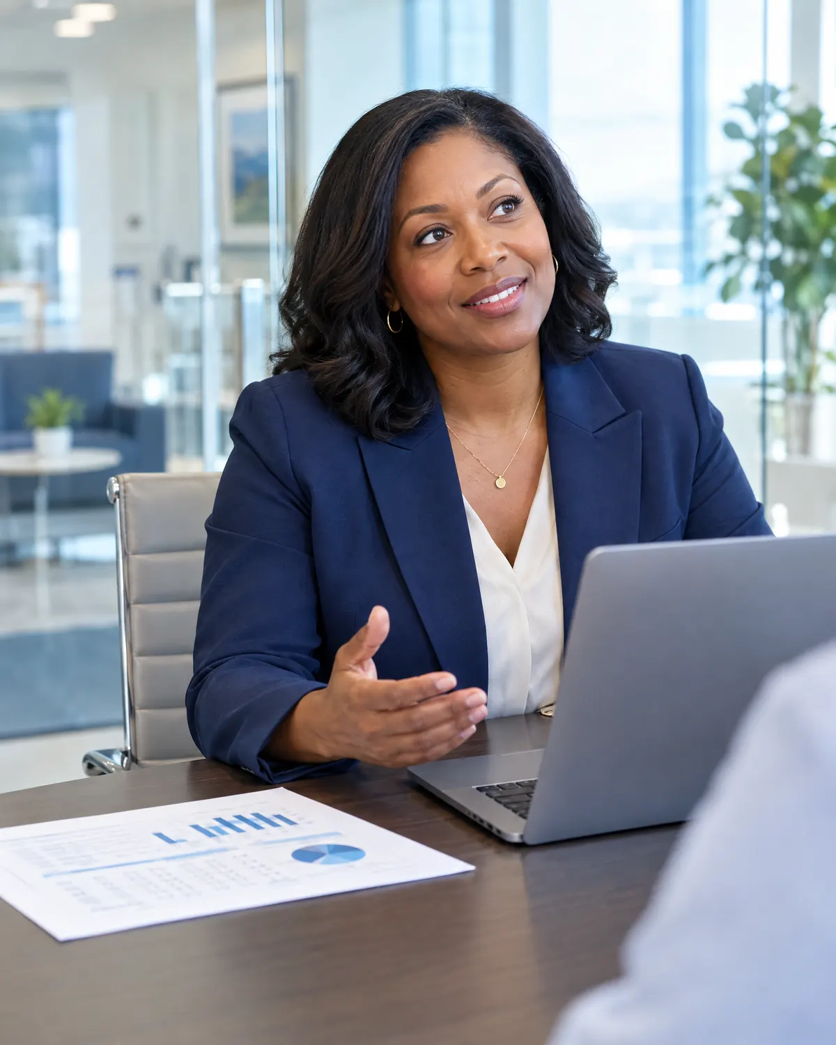 Practice administrator with a laptop and financial summary explaining results in a conference room