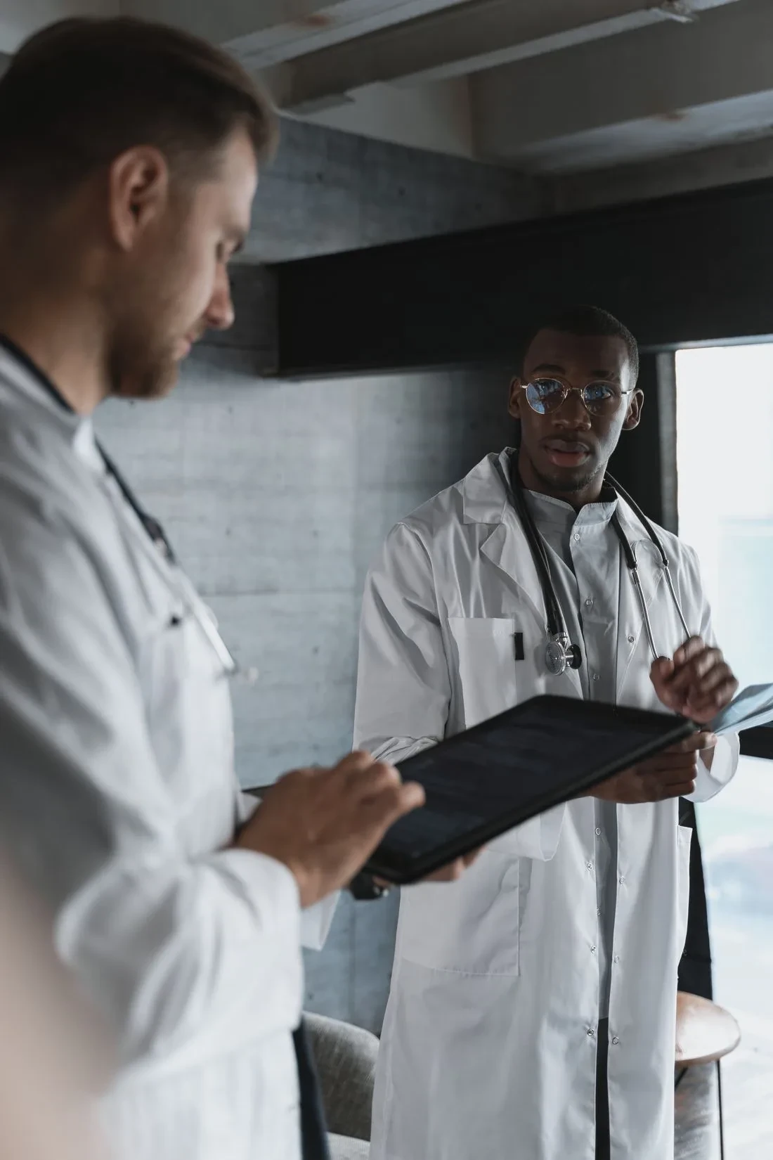 Specialty healthcare RCM partners: two healthcare professionals reviewing work on a digital tablet